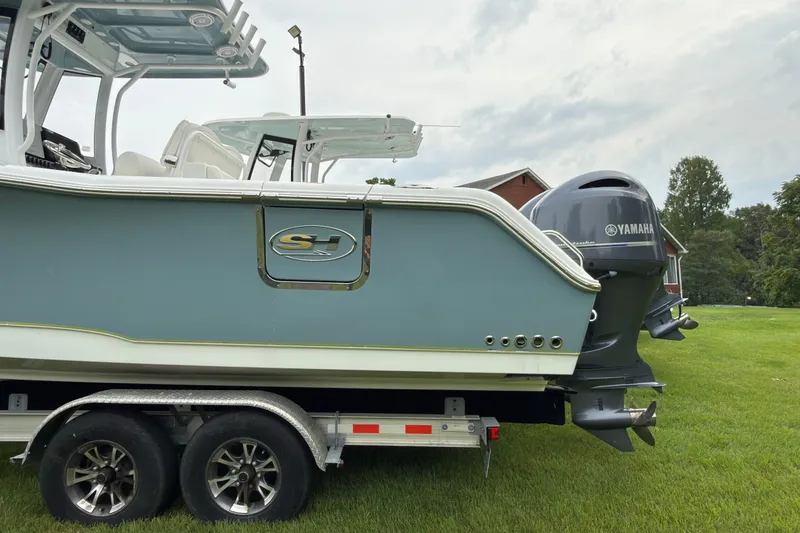 Slide: The Image of 2019 Sea Hunt Gamefish 27 boat on trailer with Yamaha outboard motor. - 2