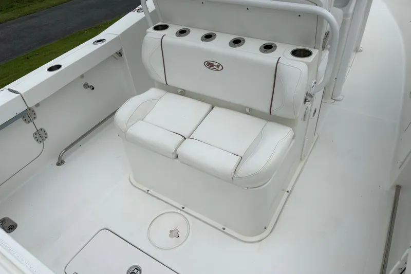 Slide: The Image of 2019 Sea Hunt Gamefish 27 boat seating area with rod holders and storage. - 10