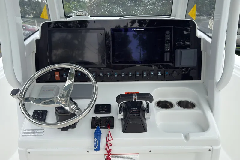 Slide: The Image of Control panel of a 2019 Sea Hunt Gamefish 27 boat with steering wheel and electronics. - 21