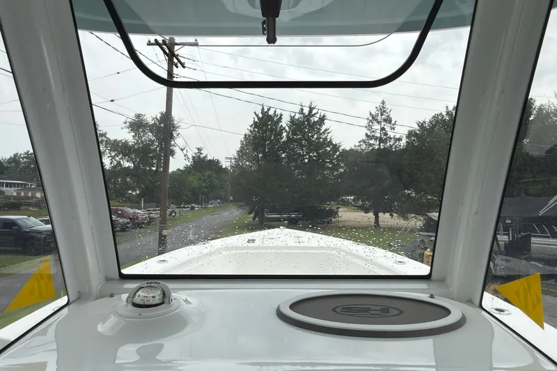 Slide: The Image of View from the helm of a 2019 Sea Hunt Gamefish 27 boat, showing windshield and compass. - 28