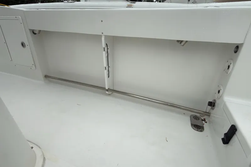 Slide: The Image of 2019 Sea Hunt Gamefish 27 boat interior, featuring clean white deck and storage area. - 34