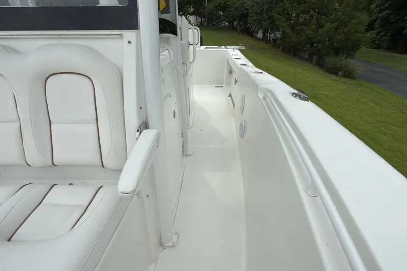 Slide: The Image of 2019 Sea Hunt Gamefish 27 boat interior with white seating and spacious deck. - 16
