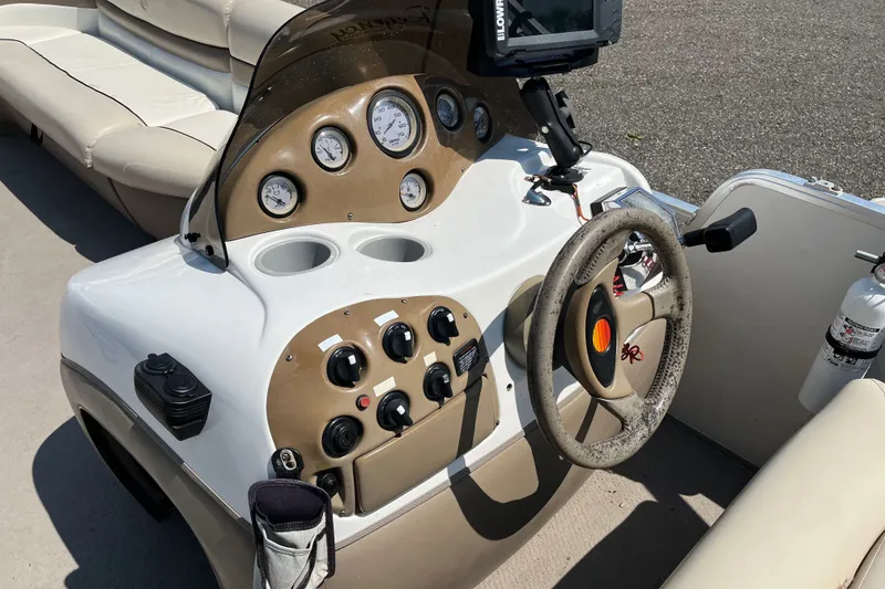 Slide: The Image of 2000 Sun Tracker Party Barge 22 I/O Regency Edition dashboard with steering wheel and controls. - 9