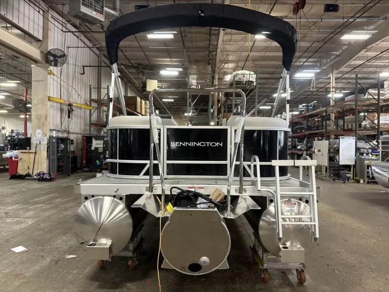 Slide: The Image of A Bennington pontoon boat, model 20 S1 STERN RADIUS, is in a warehouse. - 5
