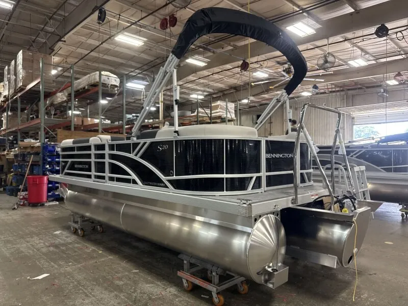 Slide: The Image of A Bennington pontoon boat, model 20 S1 STERN RADIUS, is in a warehouse. - 3