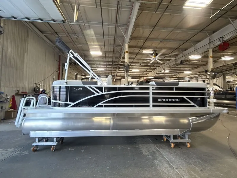 The Image of A Bennington pontoon boat, model 20 S1 STERN RADIUS, is in a warehouse. - 1