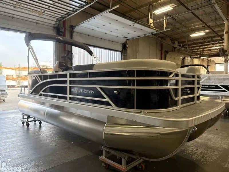 Slide: The Image of Bennington 20 S1 STERN RADIUS pontoon boat in a warehouse setting. - 4
