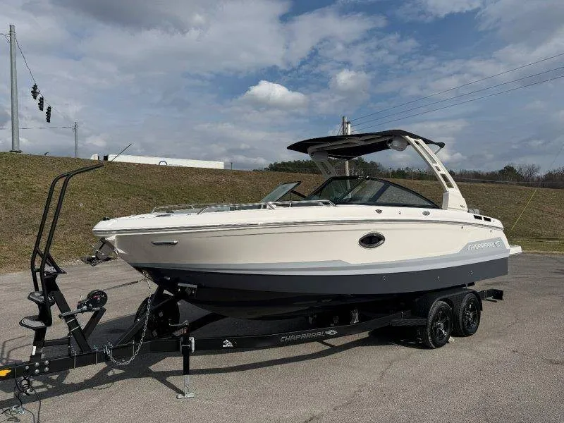 The Image of A Chaparral boat on a trailer, ready for transport. It features a modern design and two-tone paint. - 1