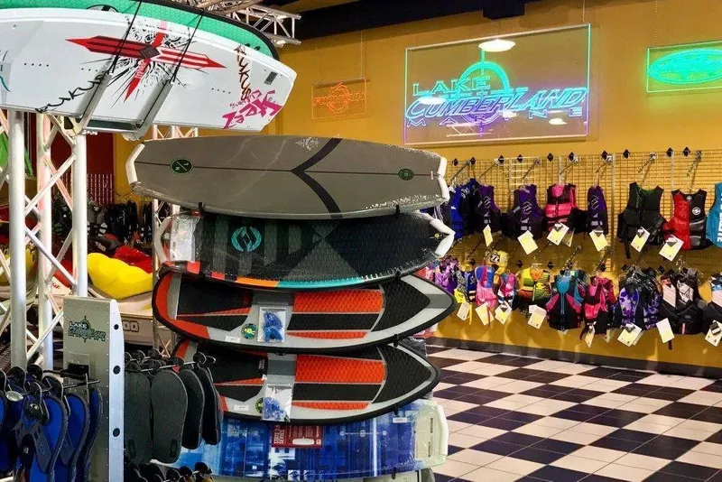 Slide: The Image of A store with surfboards and life jackets. A sign reads "Lake Cumberland" on the wall. - 14