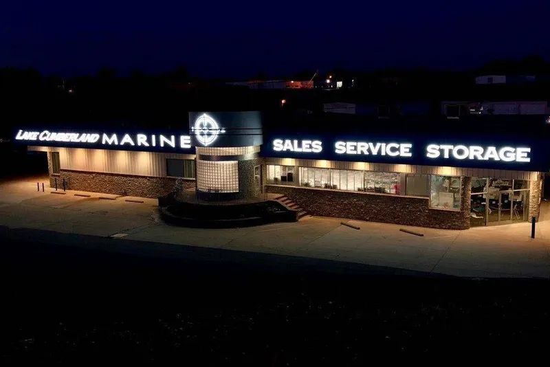 Slide: The Image of Lake Cumberland Marine at night with illuminated signs for sales, service, and storage. - 10