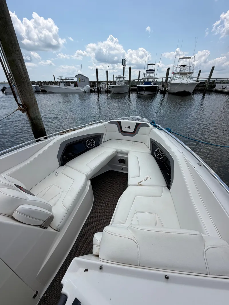 Slide: The Image of The image shows the bow seating area of a 2013 Monterey 288SS Super Sport boat with white upholstery. - 3