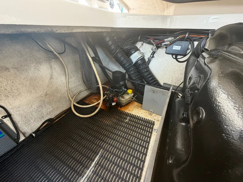 Slide: The Image of The engine compartment of a 2013 Monterey 288SS Super Sport shows hoses and wiring. - 16