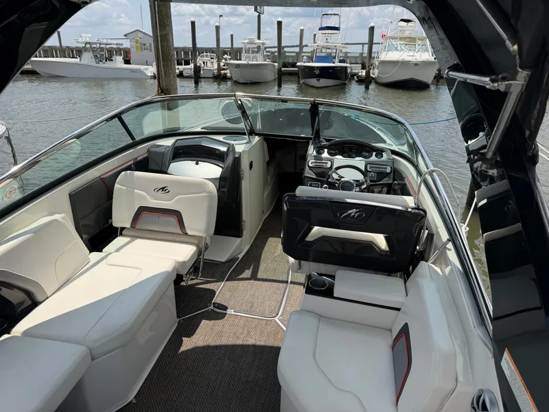 Slide: The Image of The image shows the cockpit of a 2013 Monterey 288SS Super Sport, featuring white seats and a modern dashboard. - 2