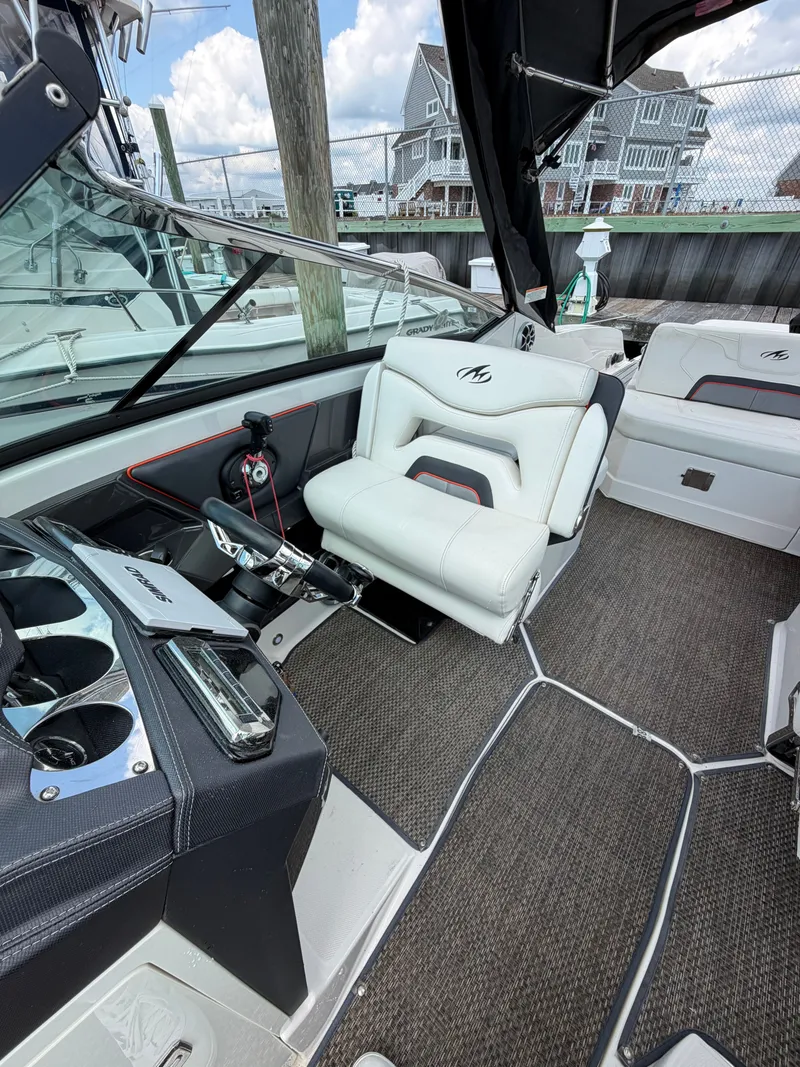 Slide: The Image of The image shows the cockpit of a 2013 Monterey 288SS Super Sport with white leather seats. - 5