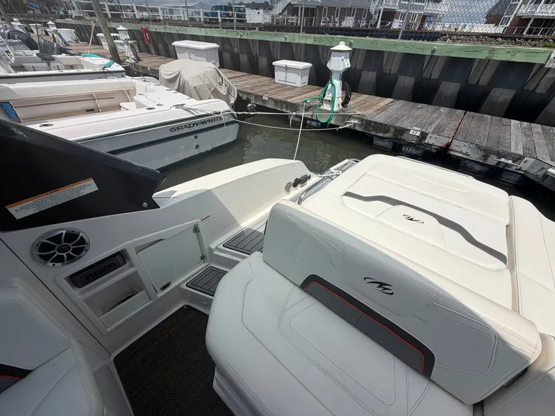 Slide: The Image of The image shows the stern of a 2013 Monterey 288SS Super Sport. It is docked in a marina. - 8