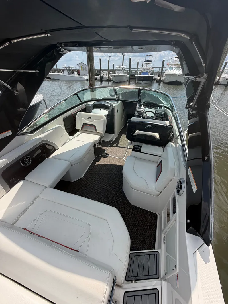 Slide: The Image of The image shows the cockpit of a 2013 Monterey 288SS Super Sport. It features white upholstery and a modern dashboard. - 1