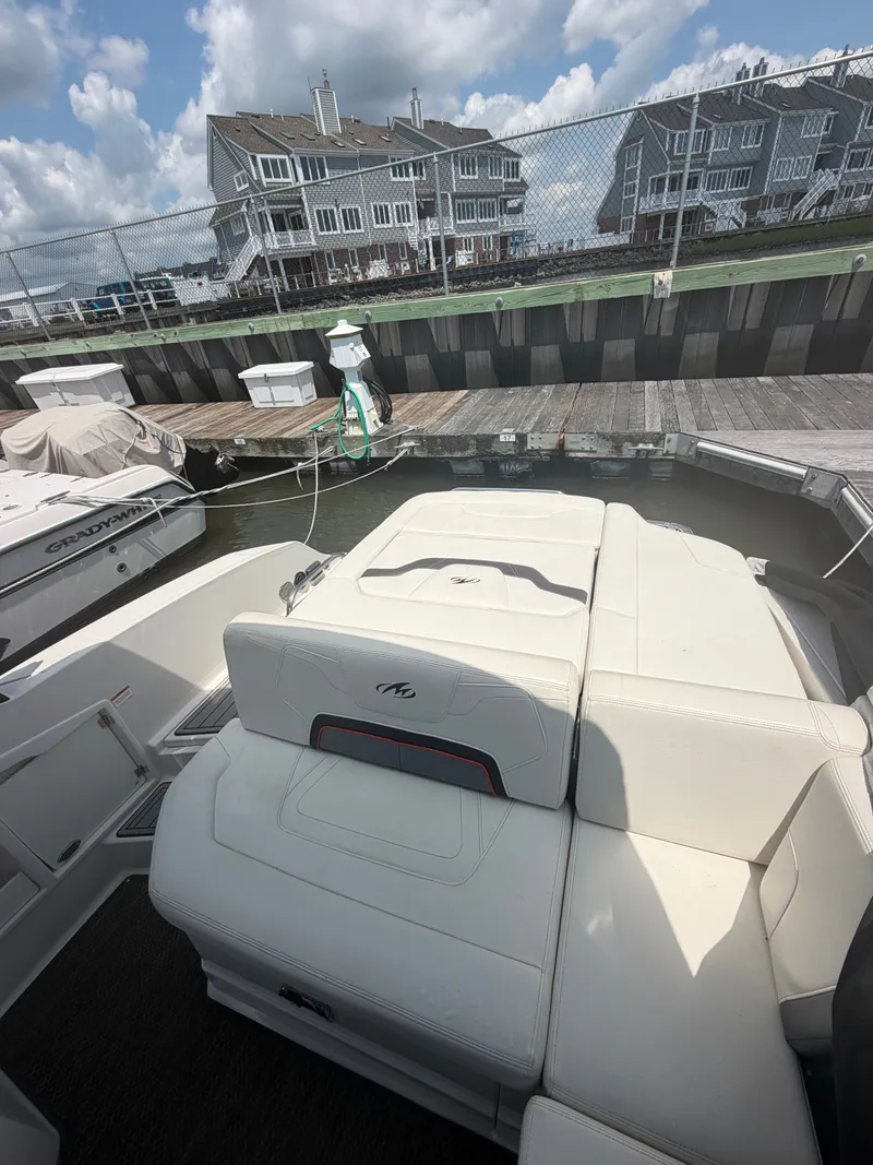 Slide: The Image of The image shows the stern of a 2013 Monterey 288SS Super Sport boat with white upholstery. - 9
