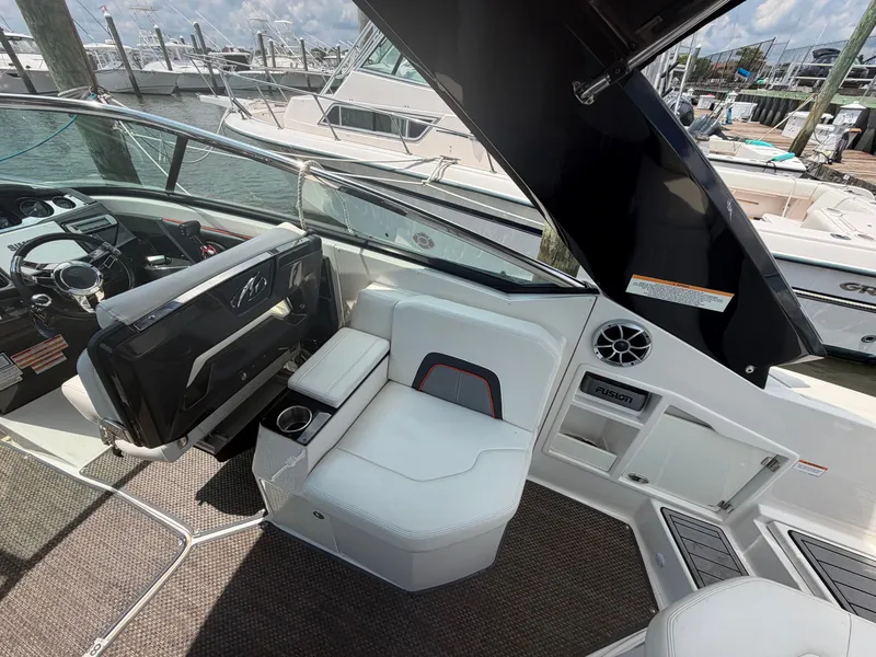 Slide: The Image of The image shows the cockpit of a 2013 Monterey 288SS Super Sport with white seating and a helm. - 7