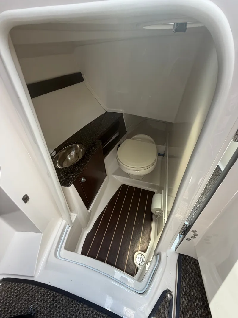 Slide: The Image of Interior view of a boat cabin with a toilet, sink, and wooden floor. - 10