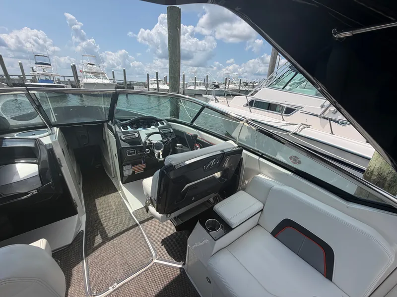 Slide: The Image of The image shows the cockpit of a 2013 Monterey 288SS Super Sport. It features white upholstery and a modern dashboard. - 6