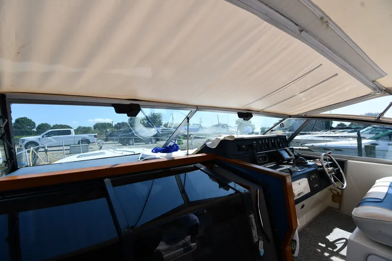 Slide: The Image of Interior view of 1989 Sea Ray 390 Express Cruiser cockpit with steering wheel and dashboard. - 8
