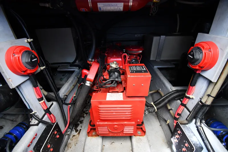 Slide: The Image of Engine compartment of 1989 Sea Ray 390 Express Cruiser with red machinery and wiring. - 43
