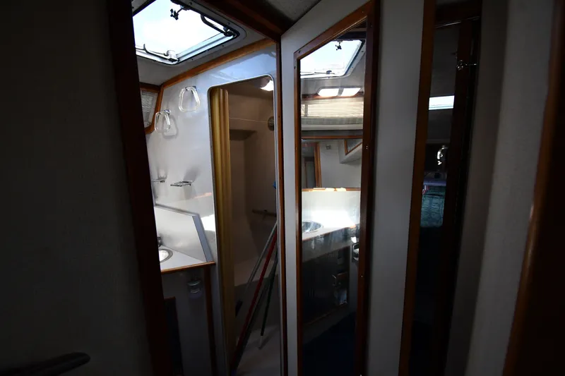 Slide: The Image of Interior view of 1989 Sea Ray 390 Express Cruiser with mirrors and skylight. - 32