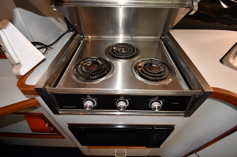Slide: The Image of Stainless steel stove in 1989 Sea Ray 390 Express Cruiser kitchen area. - 35
