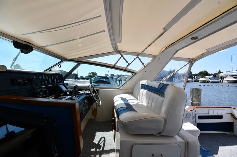 Slide: The Image of Interior view of 1989 Sea Ray 390 Express Cruiser with helm and seating. - 14