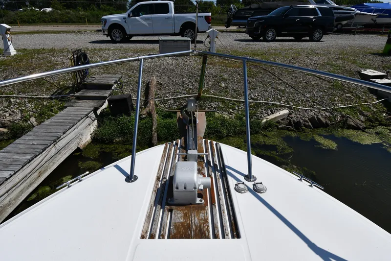 Slide: The Image of Bow view of 1989 Sea Ray 390 Express Cruiser docked near vehicles. - 5