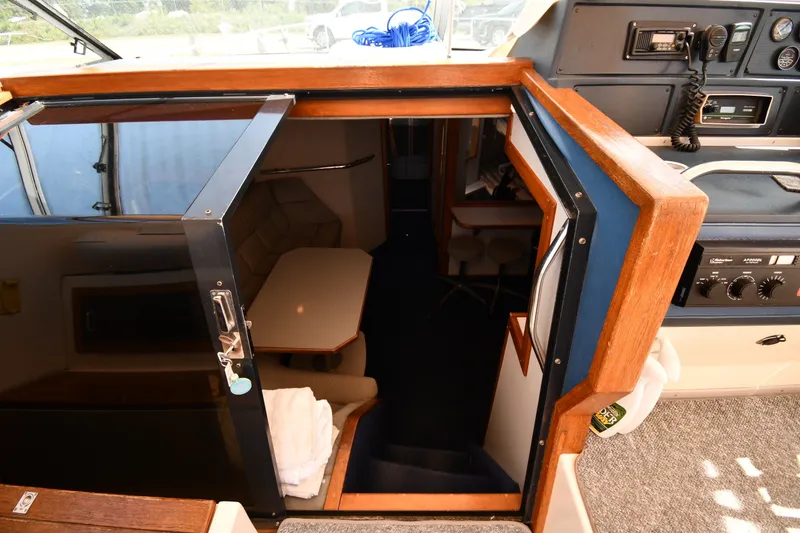 Slide: The Image of 1989 Sea Ray 390 Express Cruiser interior cabin with seating and control panel. - 20