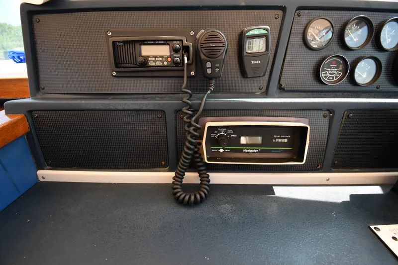 Slide: The Image of Control panel of a 1989 Sea Ray 390 Express Cruiser with navigation and communication equipment. - 11
