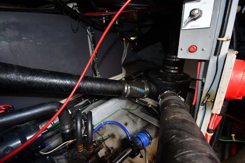 Slide: The Image of Engine room of 1989 Sea Ray 390 Express Cruiser with visible pipes and wiring. - 45