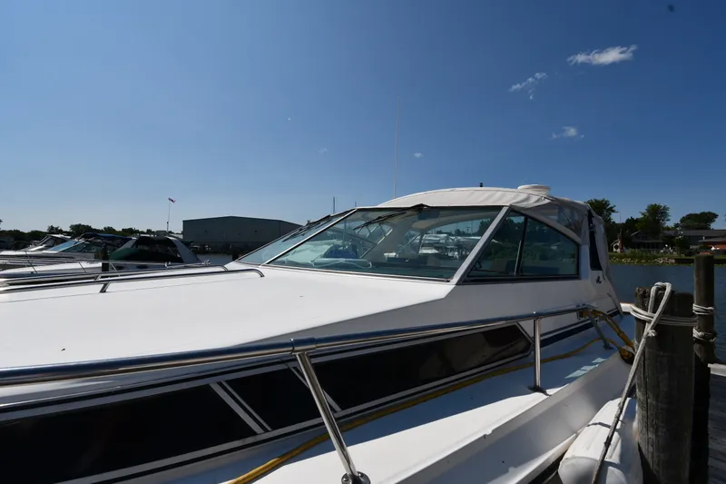 Slide: The Image of 1989 Sea Ray 390 Express Cruiser docked under clear blue sky. - 3