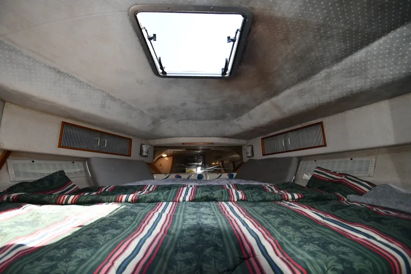 Slide: The Image of Interior cabin of 1989 Sea Ray 390 Express Cruiser with bed and overhead hatch. - 22
