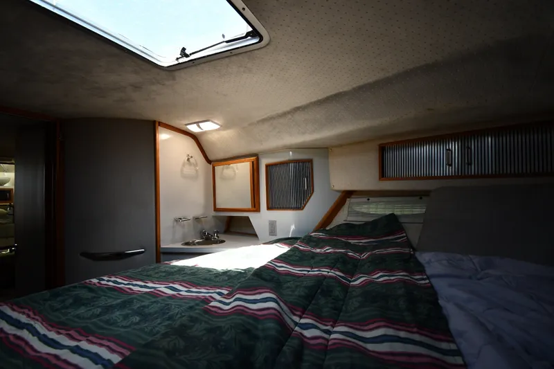 Slide: The Image of Interior cabin of 1989 Sea Ray 390 Express Cruiser with bed and skylight. - 25