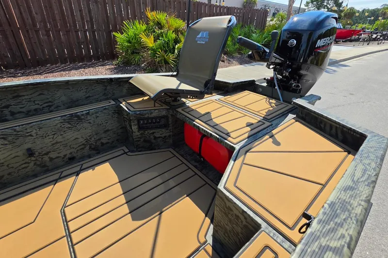 Slide: The Image of 2026 Tracker Grizzly 1650 T Prairie Wings Edition boat interior with Mercury engine. - 13