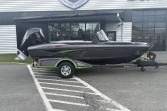 Slide: The Image of 2026 Ranger 1880MS boat on trailer, parked outside a building. - 1