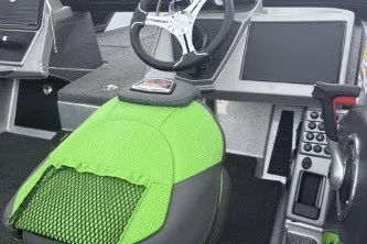Slide: The Image of 2026 Ranger 1880MS boat interior with green seat, steering wheel, and control panel. - 6