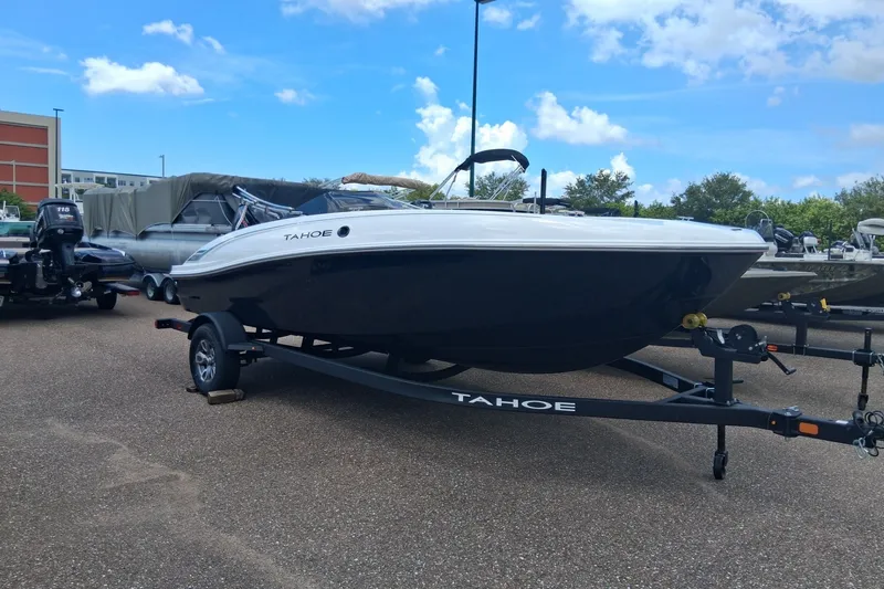 The Image of 2026 Tahoe T18 boat on trailer under blue sky at dealership. - 0