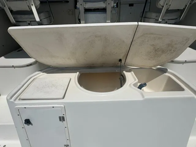 Slide: The Image of The image shows an open sink and storage area on a boat, surrounded by white surfaces. - 15
