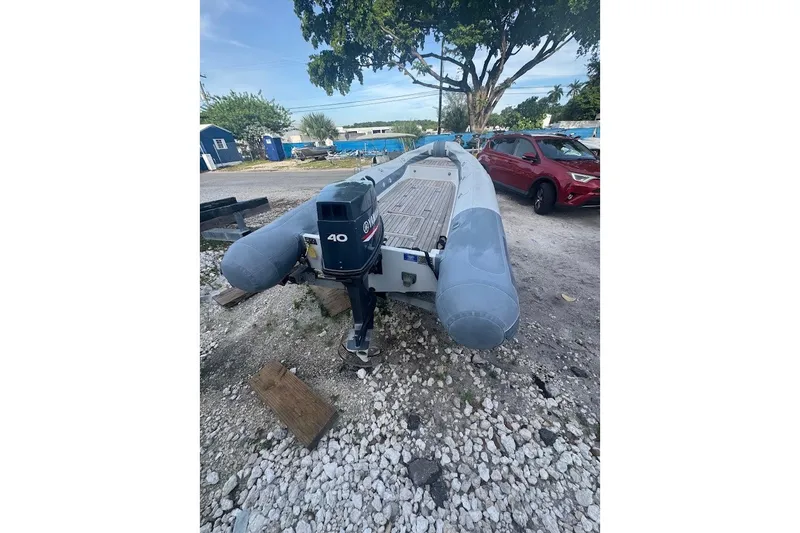 Slide: The Image of Inflatable boat with Yamaha 40 engine, parked outdoors, Embarkation Polymer 2011 model. - 2