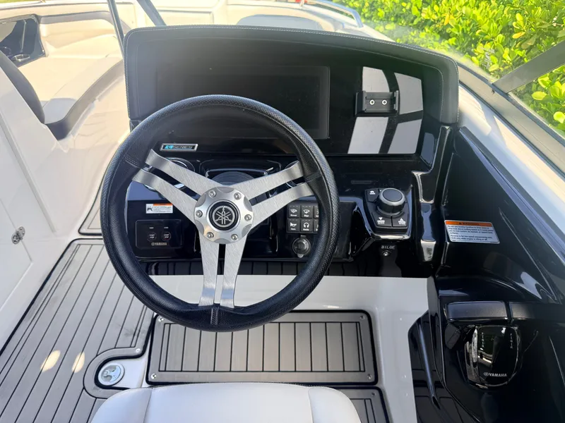 Slide: The Image of The image shows the helm of a 2020 Yamaha Boats 242SE with a modern dashboard. - 9