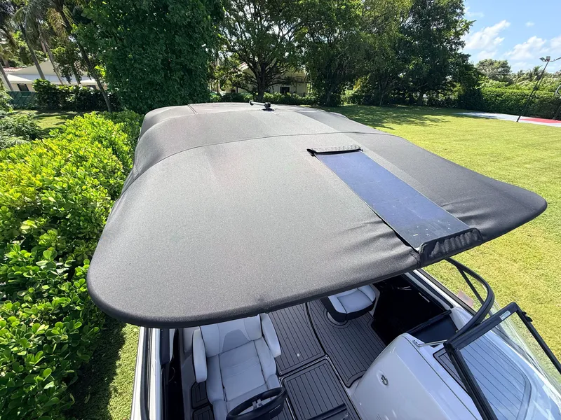 Slide: The Image of The image shows a 2020 Yamaha 242SE boat with a large black sunshade. - 16