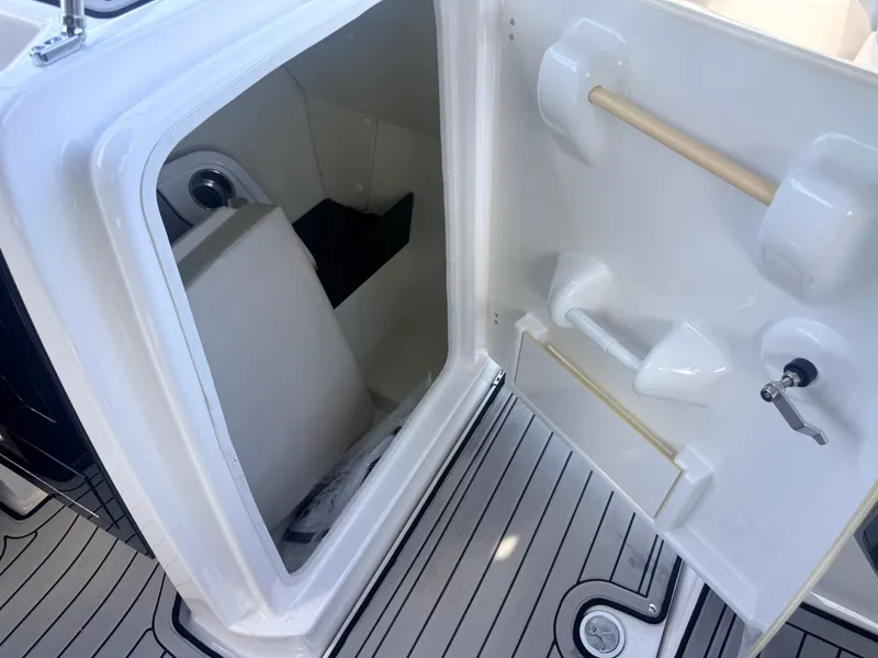 Slide: The Image of Interior of a 2020 Yamaha 242SE boat featuring storage space and grab handles. - 8