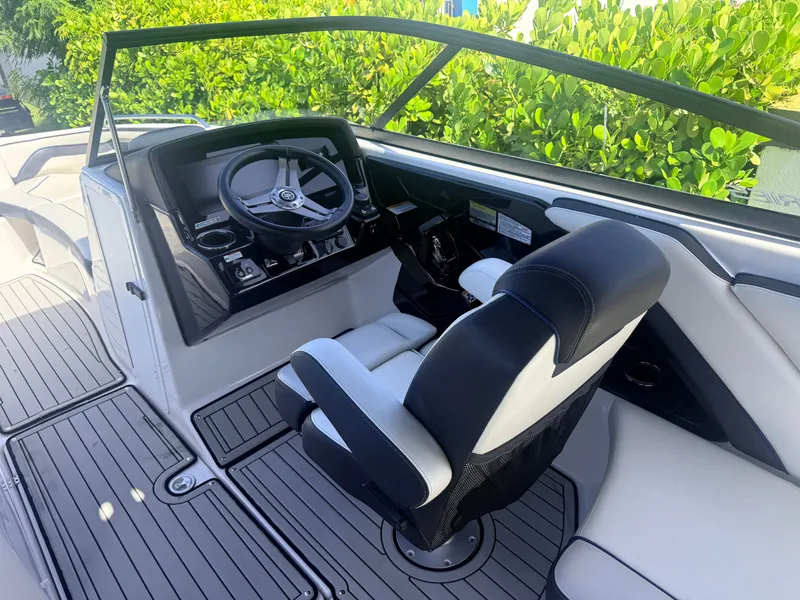 Slide: The Image of The image shows the cockpit of a 2020 Yamaha 242SE boat with a modern helm. - 7