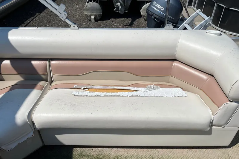 Slide: The Image of 2001 SMOKERCRAFT boat seat with torn upholstery and visible wear. - 10