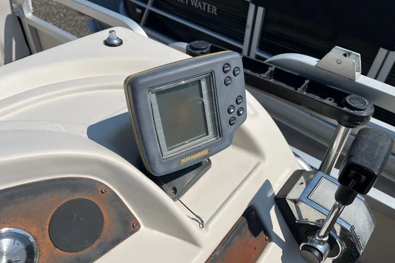 Slide: The Image of 2001 SMOKERCRAFT boat dashboard with Humminbird fish finder and control lever. - 8