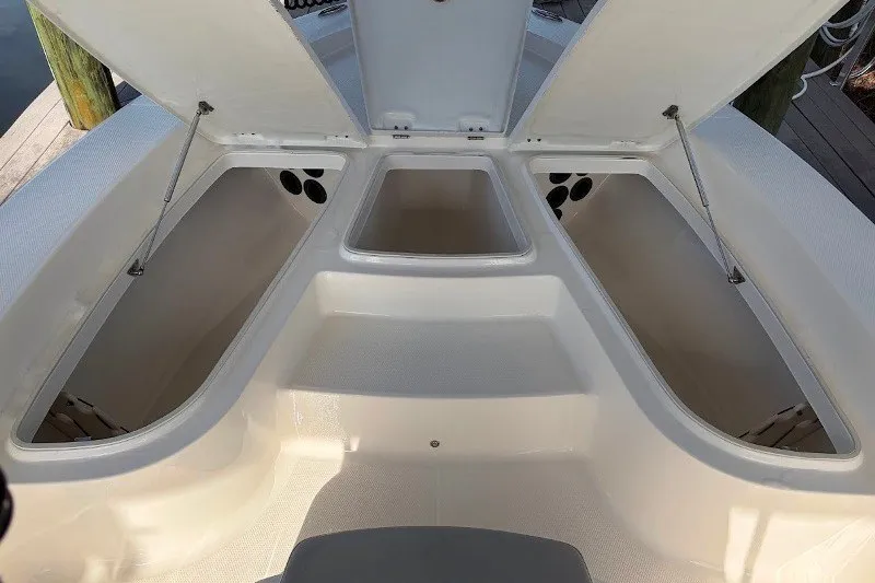 Slide: The Image of 2014 Robalo 206 Cayman boat storage compartments open, showcasing spacious interior design. - 10