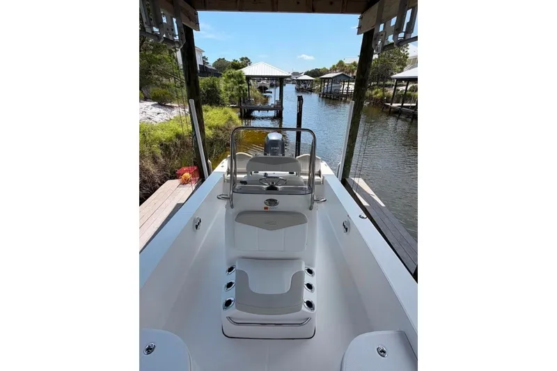 Slide: The Image of 2014 Robalo 206 Cayman boat docked by a scenic waterfront. - 8